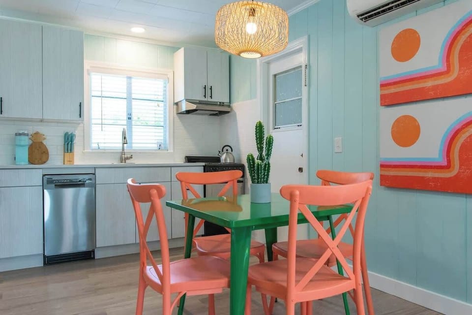 Fully stocked kitchen and dining space with stainless appliances.