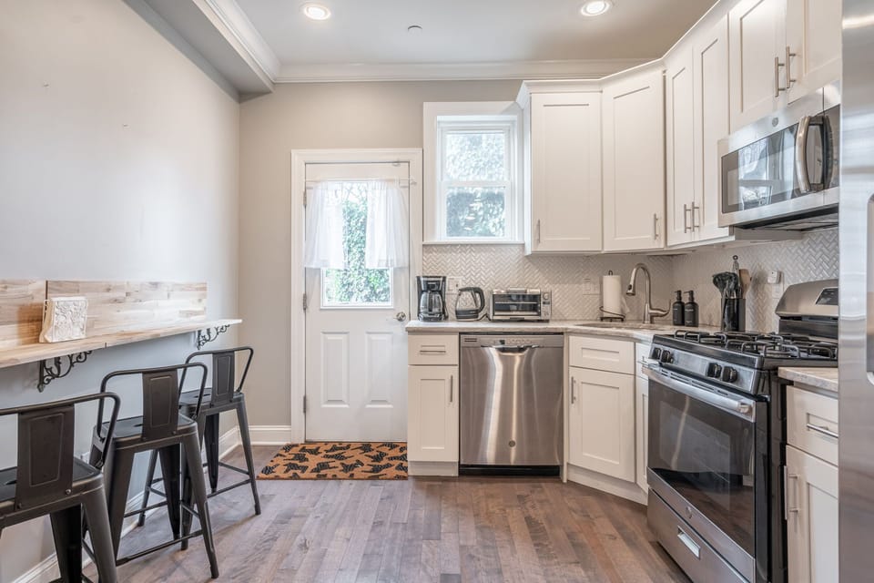 Cozy eat-in kitchen with breakfast nook, storage and warm natural light.