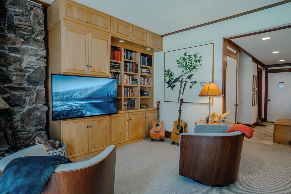 Comfortable living room featuring a cozy fireplace and mounted flat-screen TV