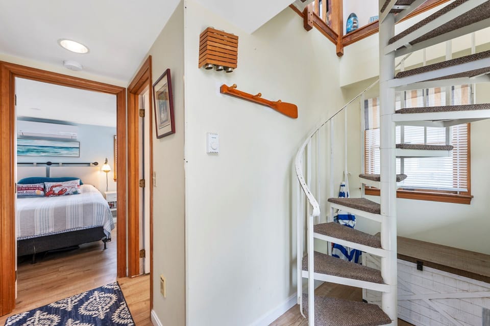Spiral staircase upstairs to living room and kitchen
