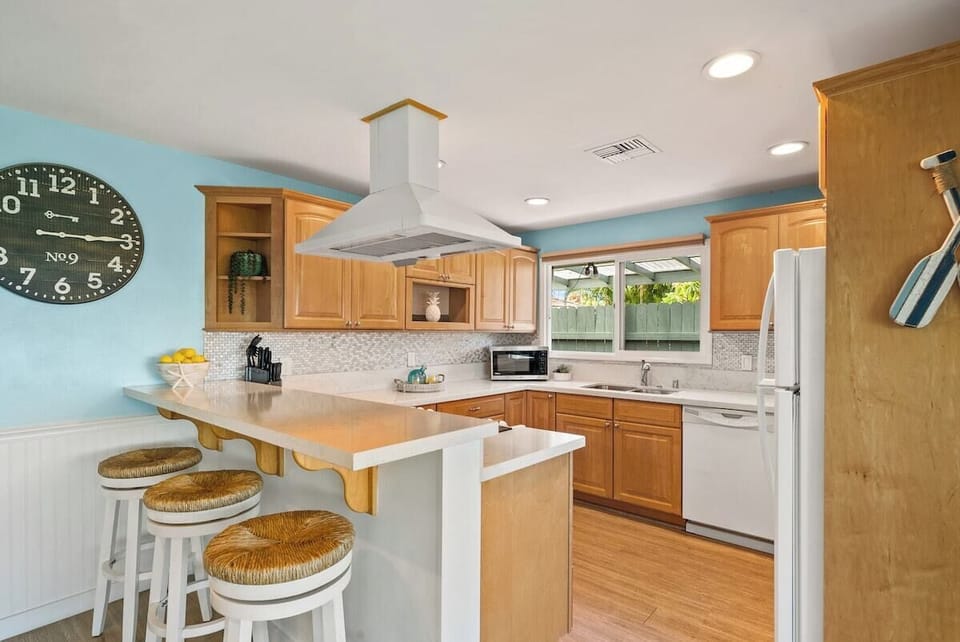 A kitchen counter with 3 bar stools, perfect for casual dining or morning coffee