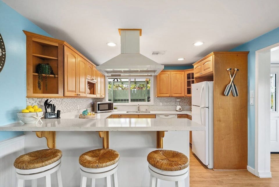 Quartz kitchen countertop with bar stools, perfect for quick meals or entertaining
