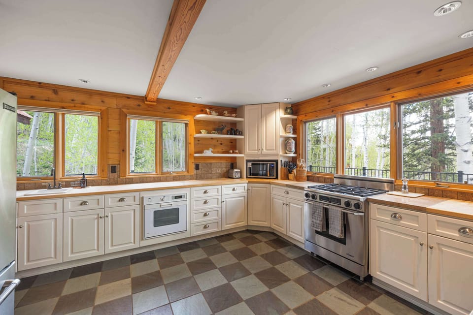 Kitchen: Main floor, Dacor oven, Jenn-Air fridge, drip coffee maker, French press, blender, toaster oven, food processor, cooking utensils, tableware