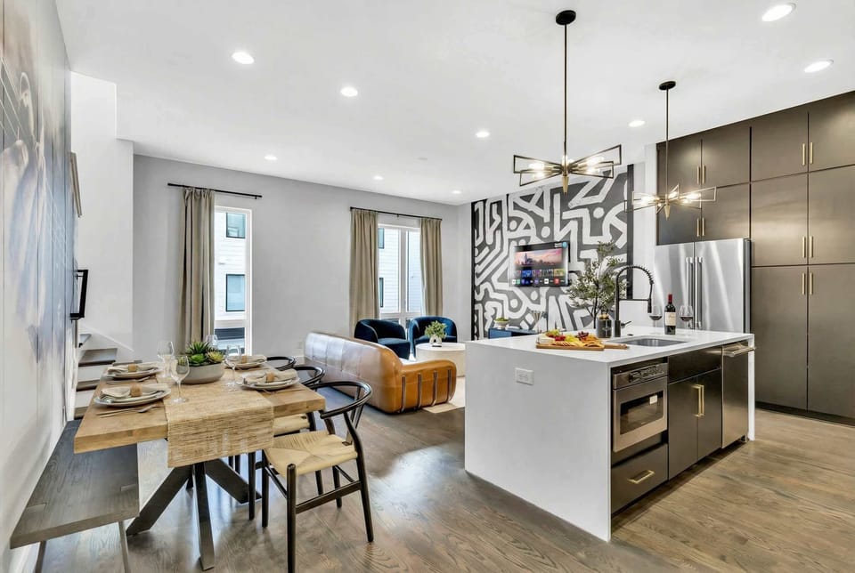 Open-plan dining flows straight into the kitchen island, so the table is never far from the coffee or wine refill during a meal