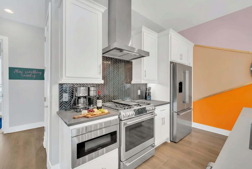 Stainless steel kitchen with an island and bar stools means the cook doesn't get left out, they stay in the conversation while you all eat together at one table