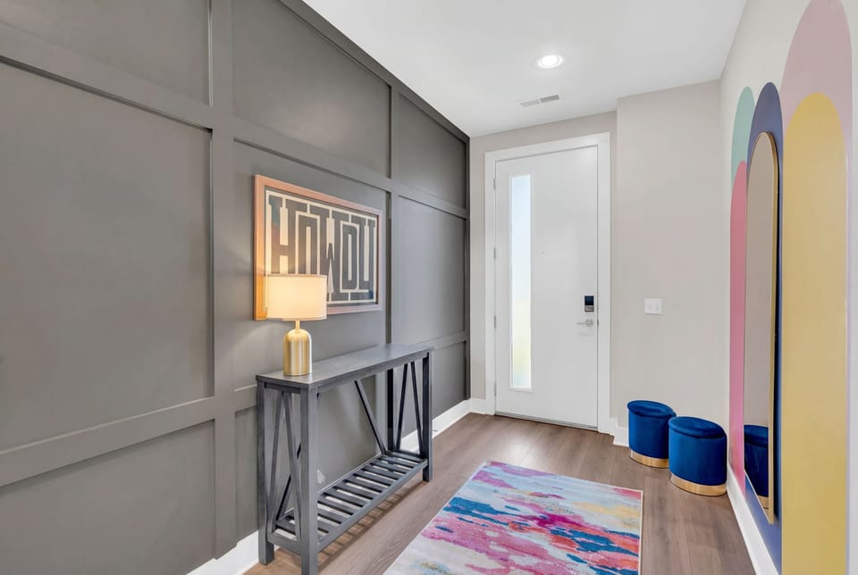 A welcoming entry sets the tone for your Nashville group getaway, with a mirror framed in bold color and a console table ready for keys and cameras