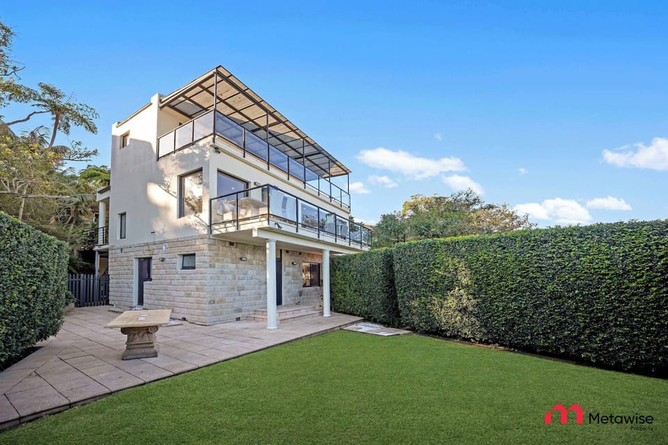 Rear exterior view with lawn area and multi-level structure.