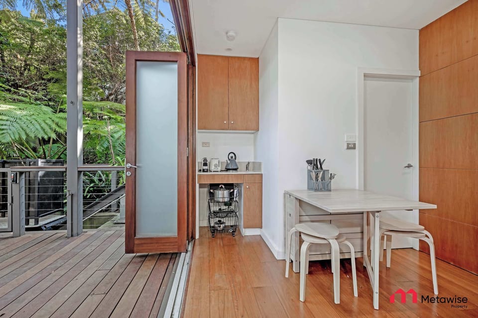 Dining nook with small table and direct access to outdoor deck.