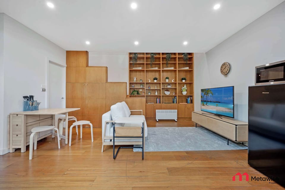 Open-plan living and dining space with lounge seating and TV area.