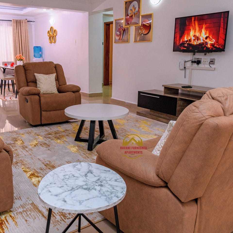 Family Apartment, City View | Living area | 24-inch Smart TV with digital channels