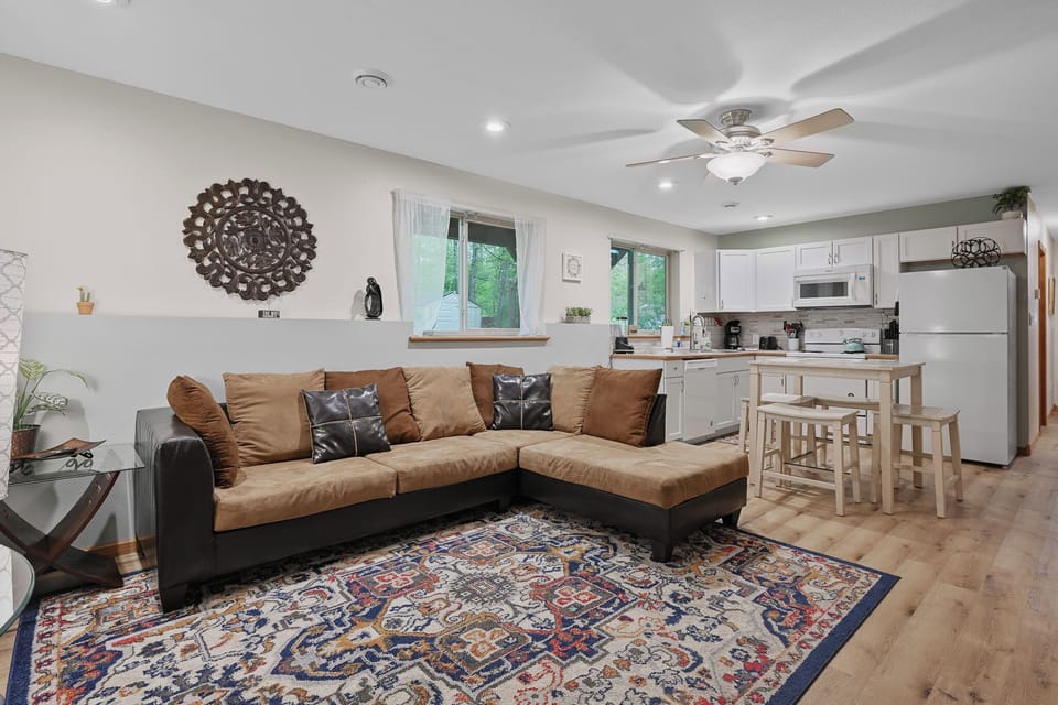 Cozy living area with a spacious sectional and open kitchen—perfect for relaxing and gathering.