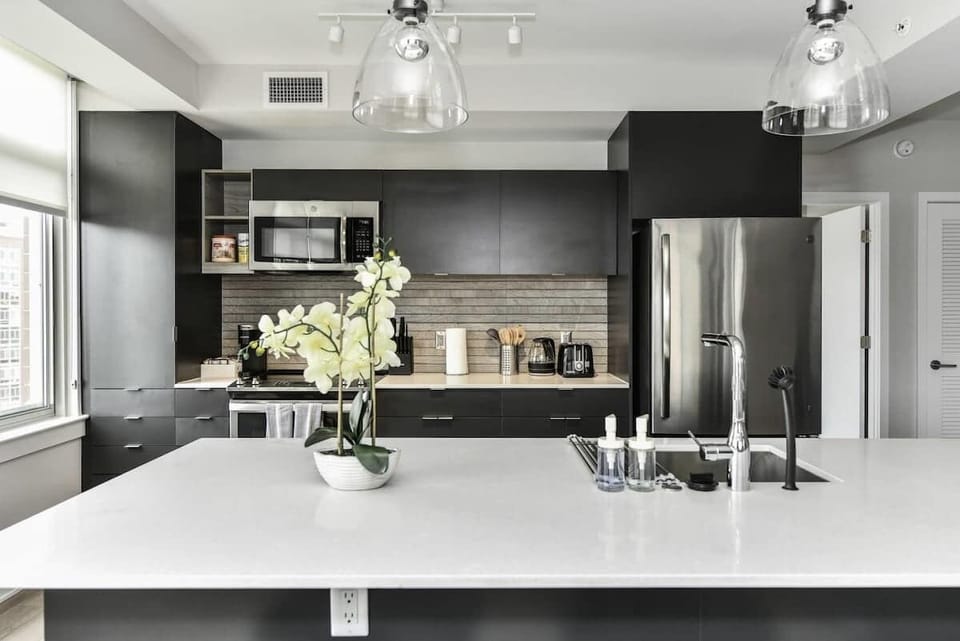 Fully equipped kitchen with a breakfast counter (seats 3) and a dining area (seats 4), plus a high chair available for little ones.