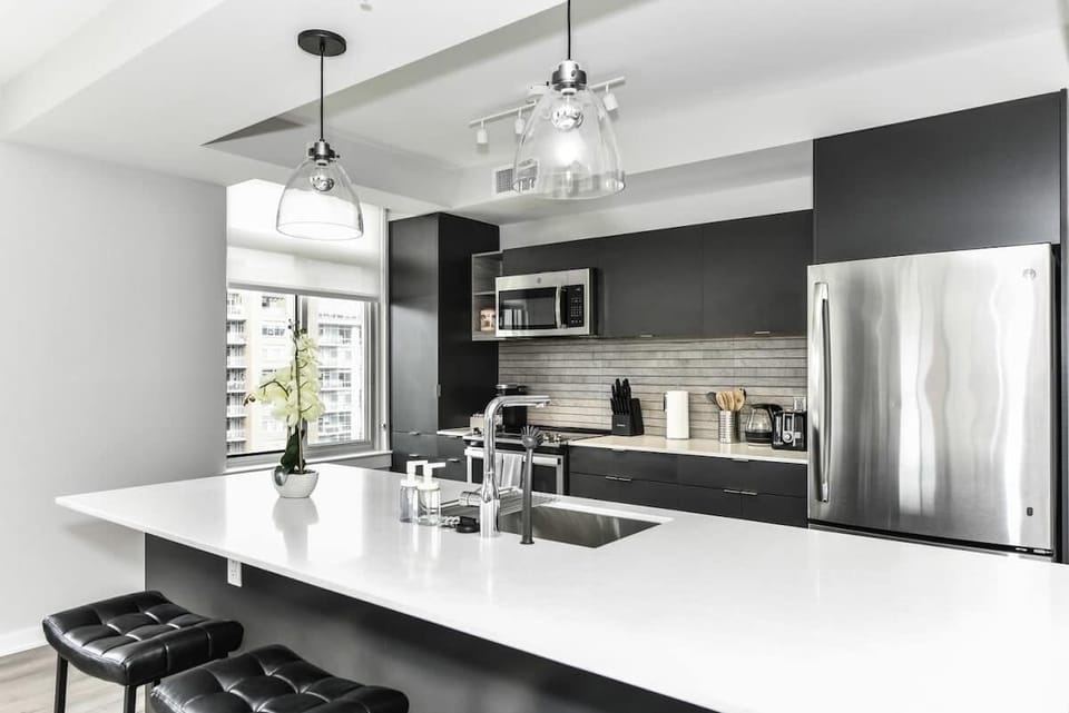 Fully equipped kitchen with a breakfast counter (seats 3) and a dining area (seats 4), plus a high chair available for little ones.