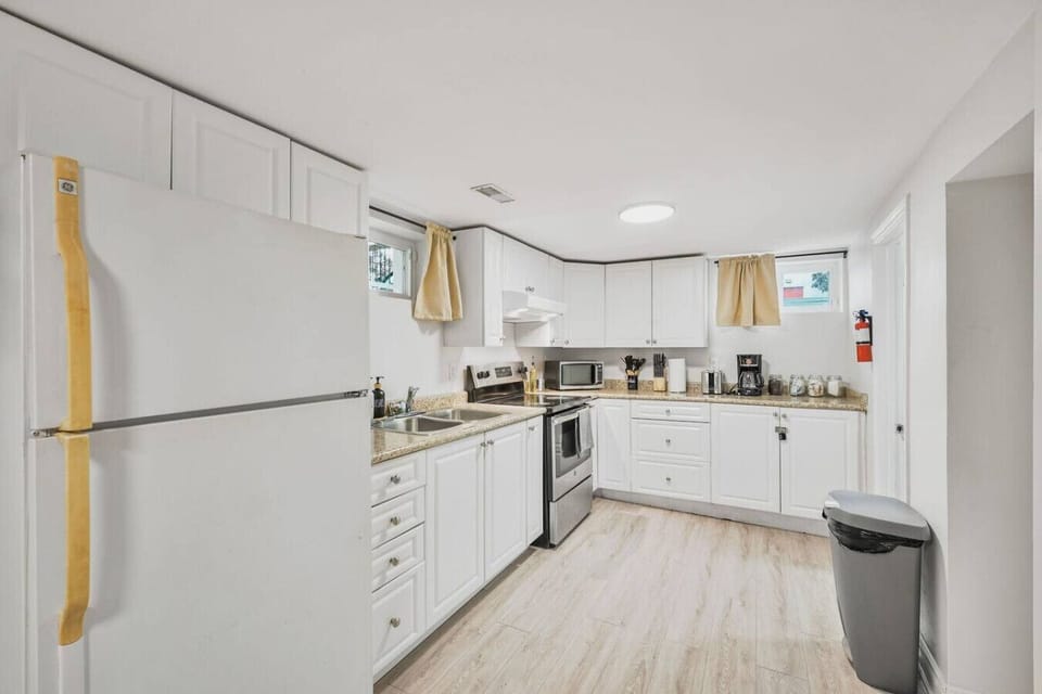 Whip up your favorite meals in this fully equipped kitchen featuring modern appliances, ample counter space, and all the essentials for a comfortable and convenient stay.