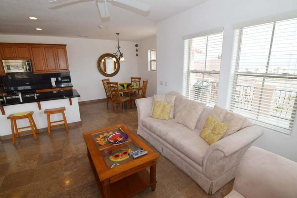 The upstairs living room features large windows with stunning golf course and ocean views — bringing natural light into the open-concept space.