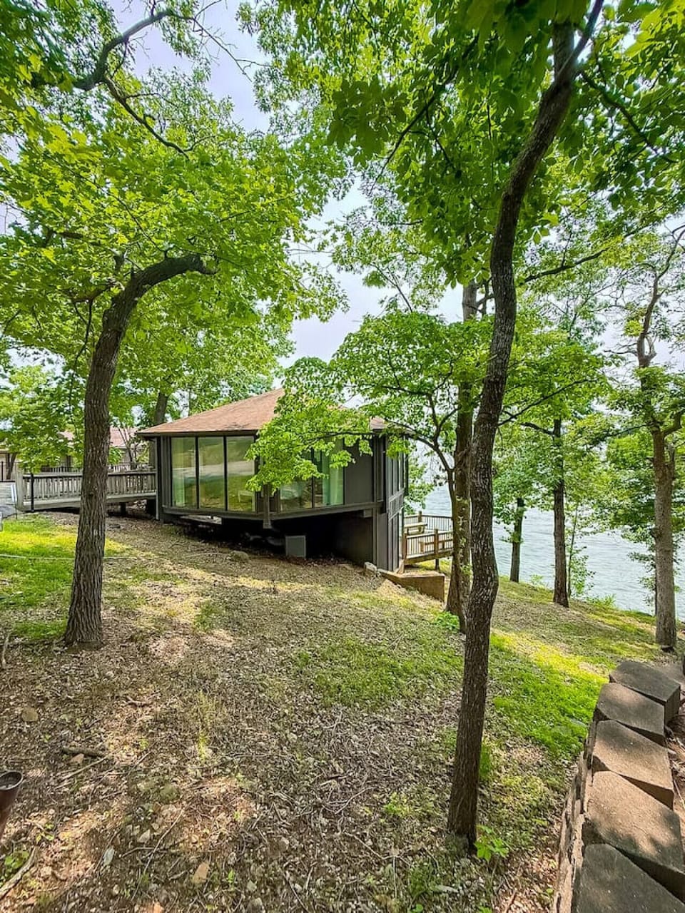 Secluded lakefront retreat nestled among trees with scenic views and private deck access
