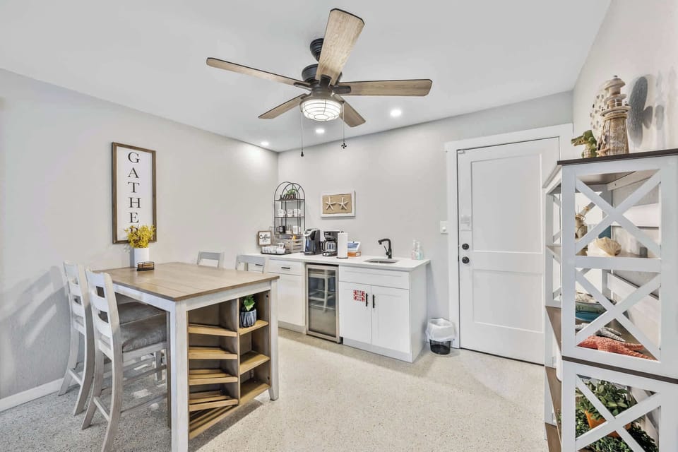 cozy kitchenette and dining area with a ceiling fan and modern lighting