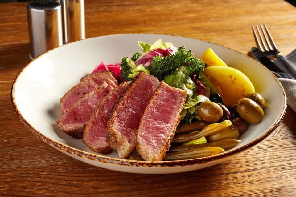 Seared tuna with salad, olives, and pickled veggies