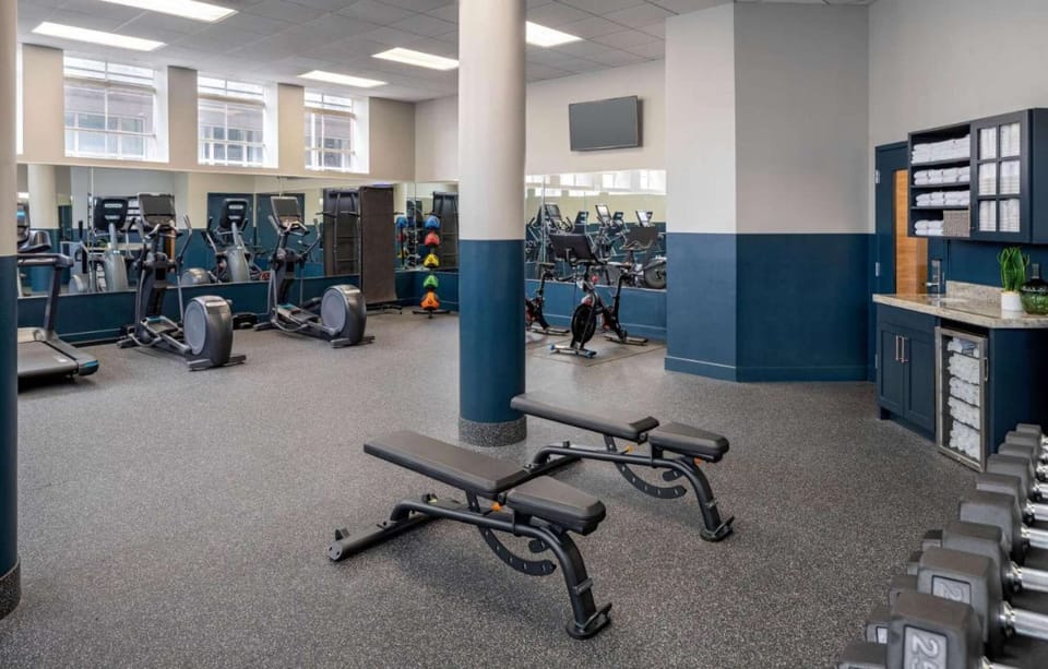 Gym with cardio machines and free weights.