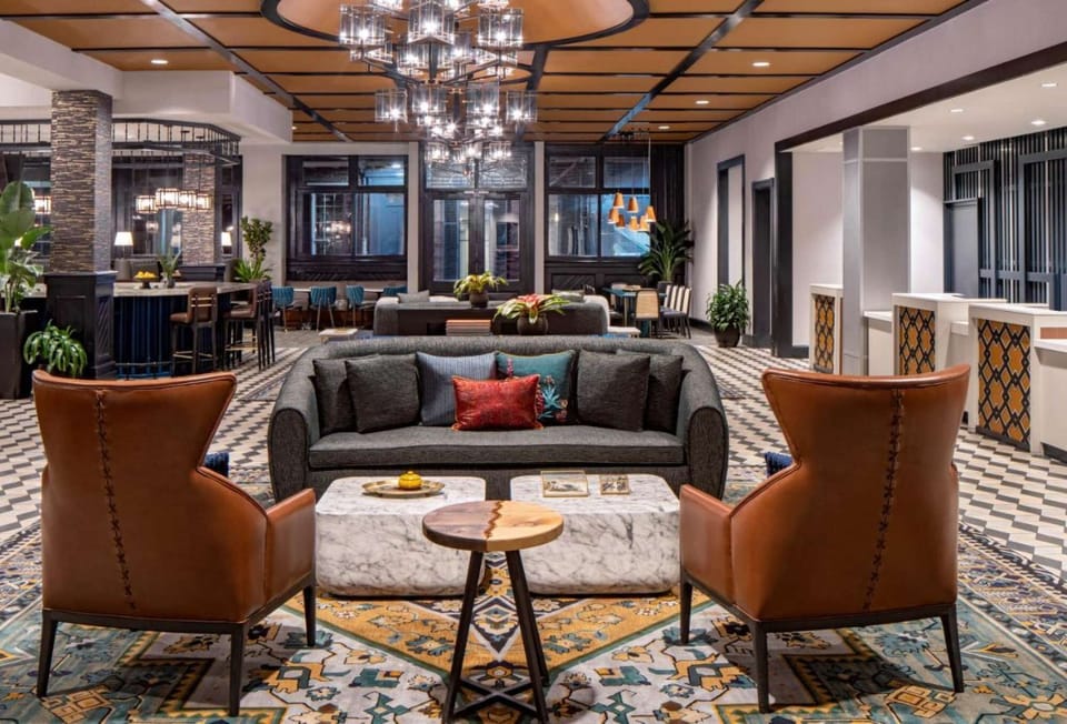 Cozy lobby with sofa, chairs, and bright chandeliers