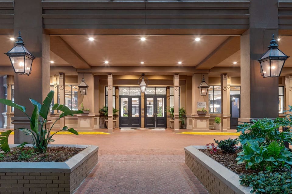 Entrance with lantern lights and potted green plants