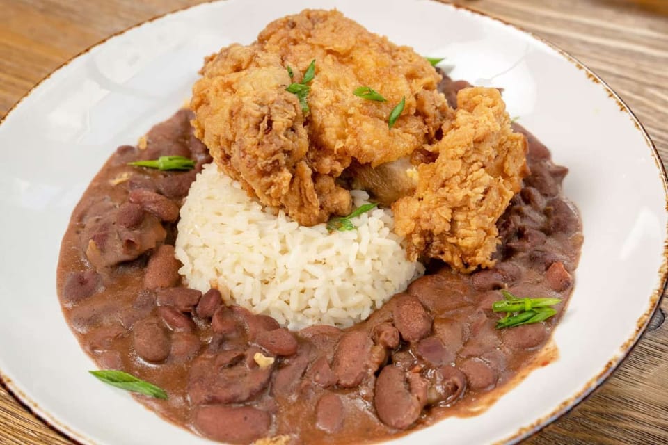 Fried chicken with rice and red beans on a plate