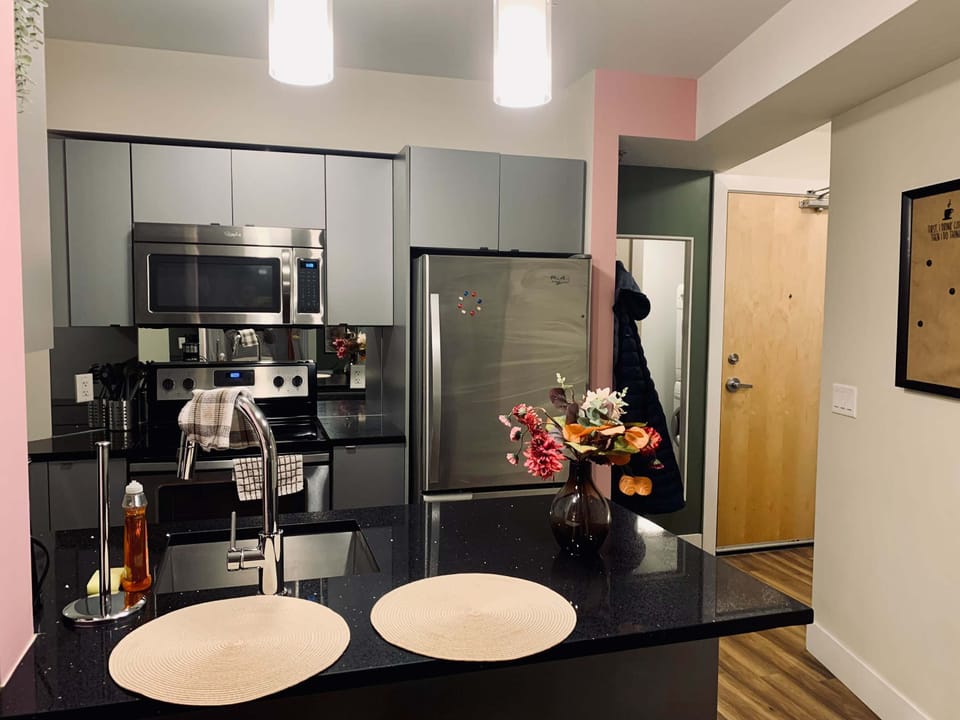 Modern kitchen with gleaming stainless steel appliances for a chef-worthy experience.