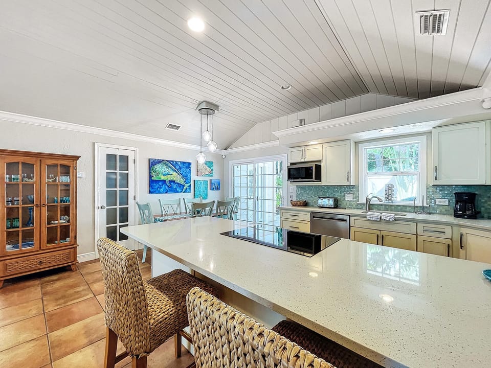 Open floor plan with volume ceilings and updated kitchen with stainless appliances