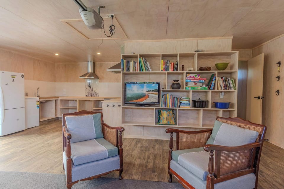 Family room with armchairs and bookshelf