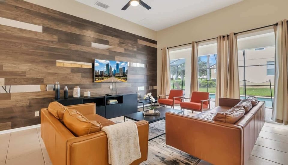 Elegant living room with a rustic wood-planked accent wall and luxurious leather seating.