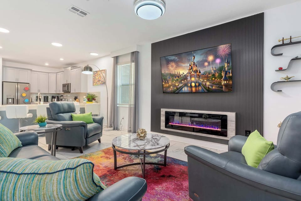 Professionally designed living room with luxurious furniture and décor, electric fireplace & 75 inch TV