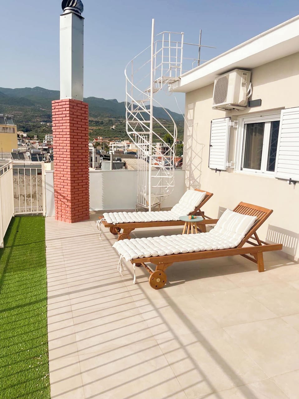 Unwind on our sunny rooftop terrace with comfortable sunbeds and stunning views of the surrounding mountains