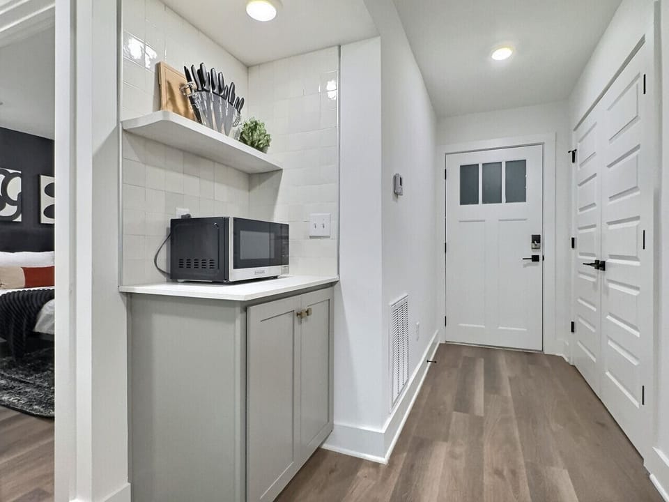Modern kitchen with sleek stainless steel appliances and neatly arranged utensils for effortless cooking.