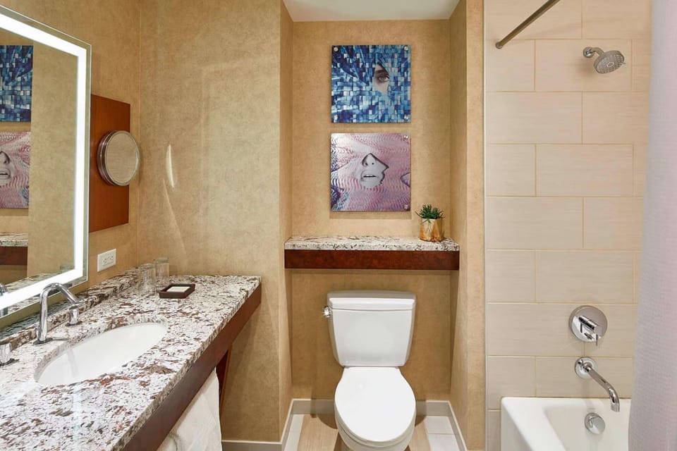 Bathroom with mirror, shower tub, and modern decor.