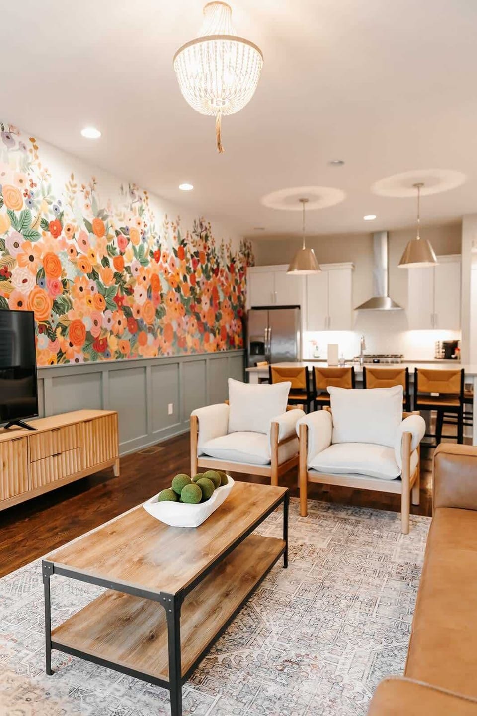 Custom wallpaper, comfy seating, large smart tv for streaming, and plenty of room for large groups
