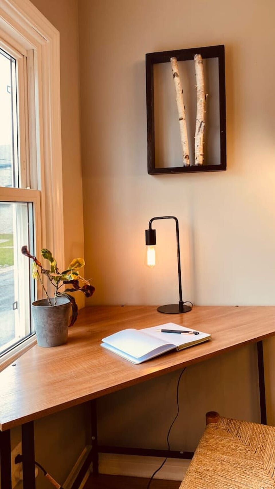 An office nook with a window for working with a view of the neighborhood.