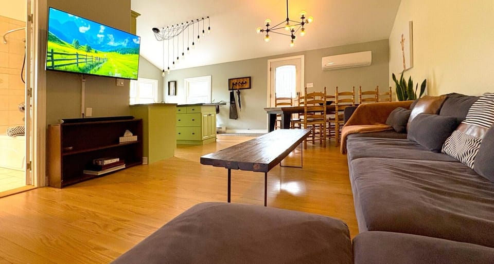 Relax and unwind in our spacious open-concept living area, featuring comfortable seating and a large Smart TV for movie nights, streaming, and staying connected.