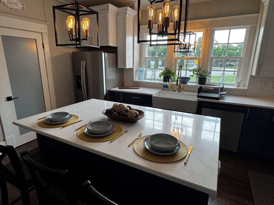 The island seats 3 with extra stools under the coffee bar. Pantry for storage.