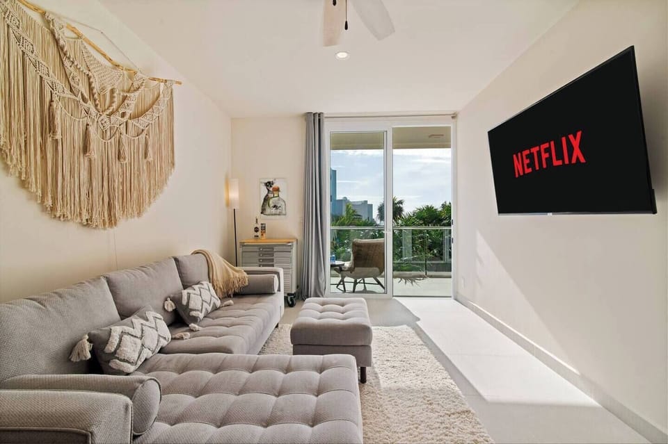 Not only does this living room have a private balcony, but it also features a 65-inch Smart TV so you can enjoy your favorite movies and shows.