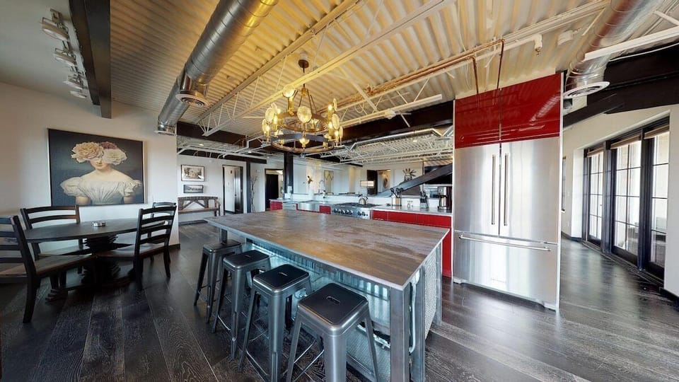 Large kitchen with spacious island and barstools for four