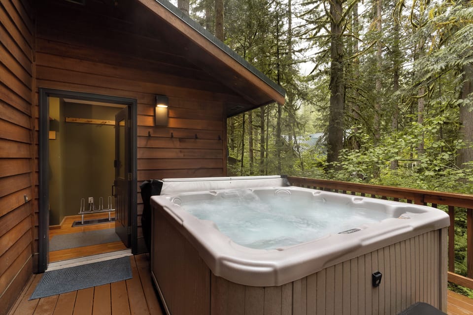 Hot tub is located at the entrance/mudroom with easy access to towels.