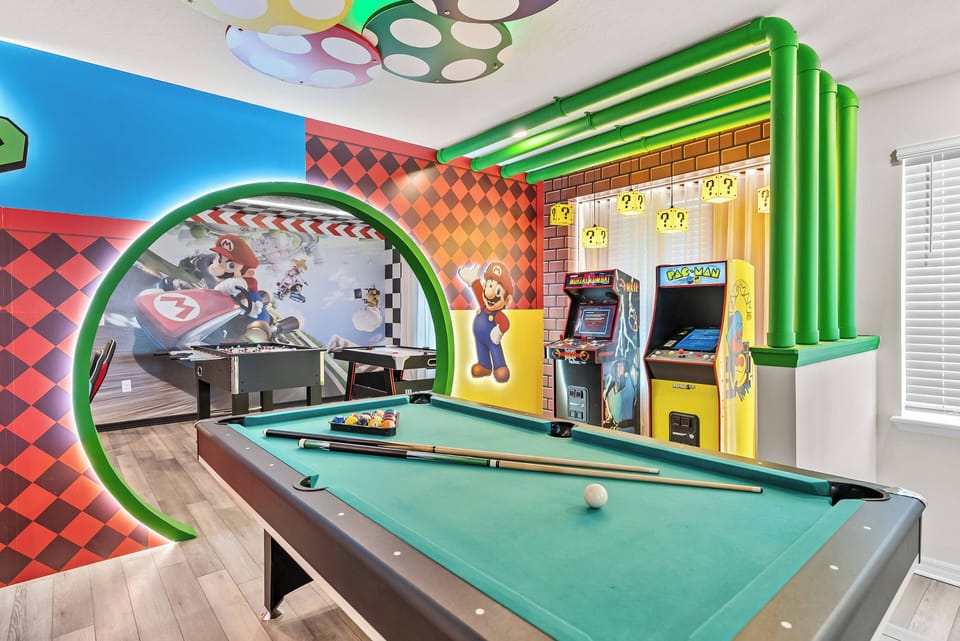 Enter a lively game room filled with joyful decor, a stunning mural, and bright green accents. Play pool on luxurious green felt and enjoy retro arcade games, all while surrounded by warm, inviting light.