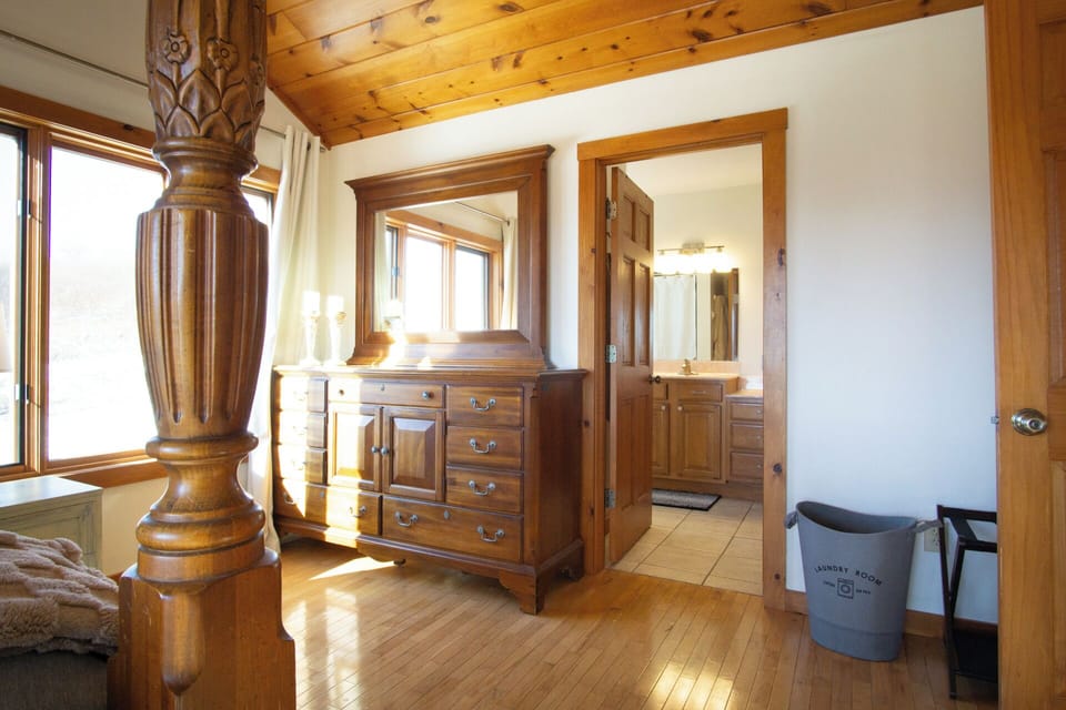 The master bedroom at Skywalker Meadow is a peaceful retreat designed with both comfort and beauty in mind. Wake up to gorgeous meadow views through large windows that fill the room with natural light.