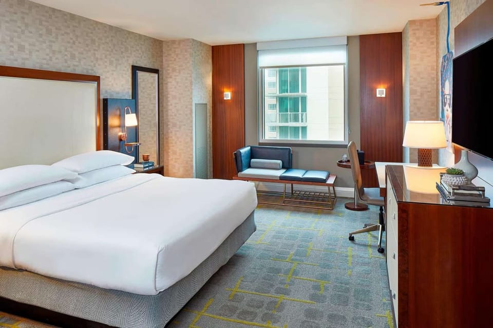 Bright bedroom with large bed and stylish furniture.