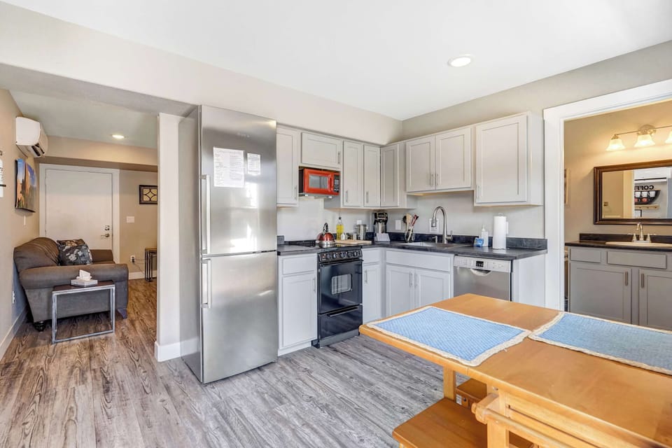 Whip up meals with ease in the fully equipped kitchen, then enjoy them at the cozy dining table with natural light streaming in.

