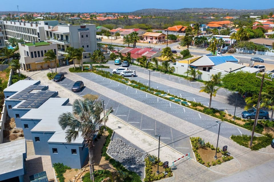 A calming pool area with loungers and tropical foliage, beautifully lit under the twilight sky.