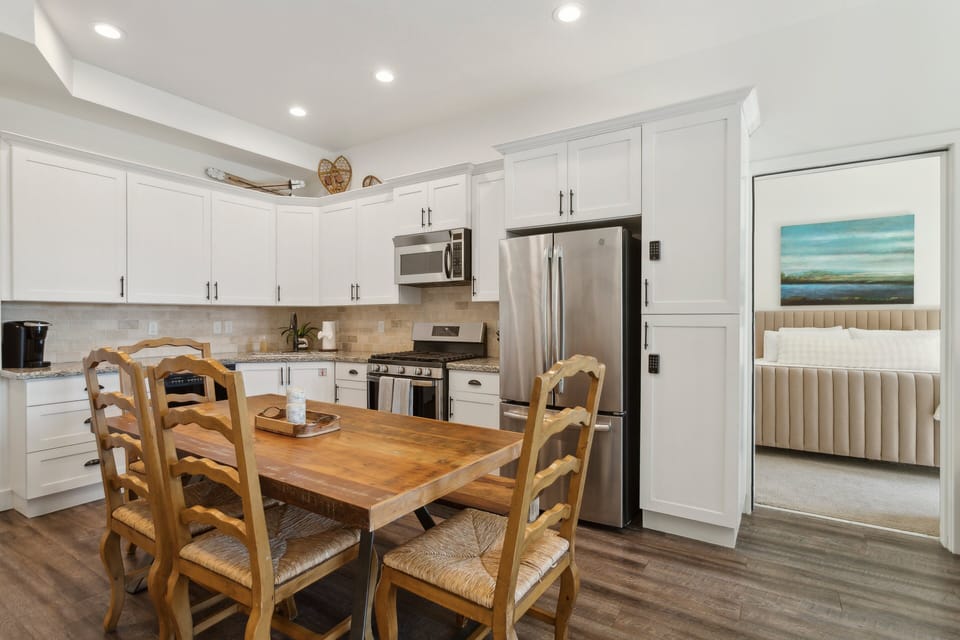 full kitchen with dining table and large fridge