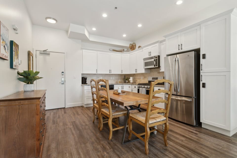 kitchen with full sized table and large fridge