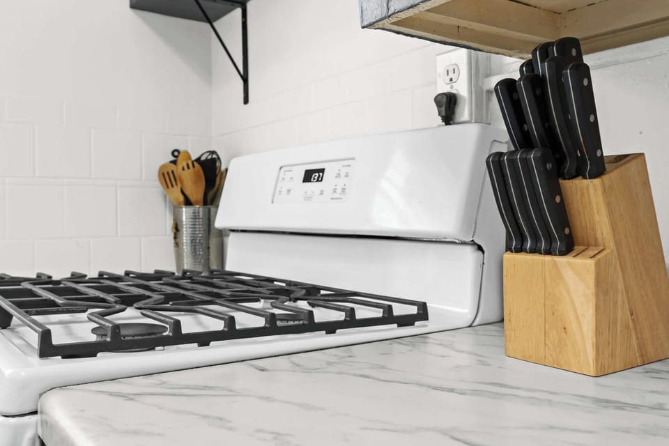 Kitchen: Unit 1 - Cook with ease in this functional kitchen featuring updated appliances and essentials.