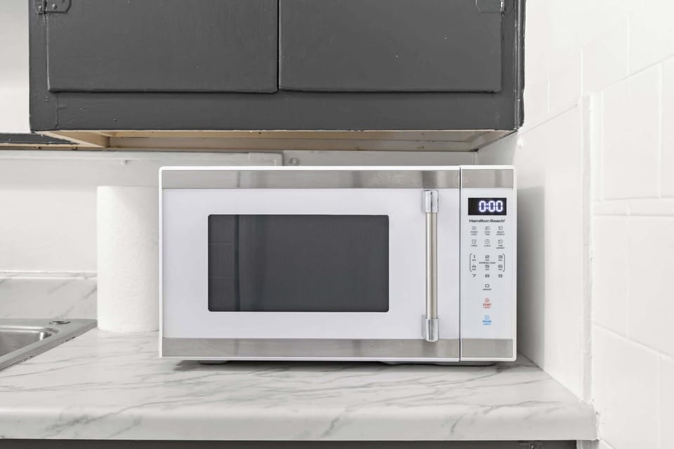 Kitchen: Unit 1 - Cook with ease in this functional kitchen featuring updated appliances and essentials.